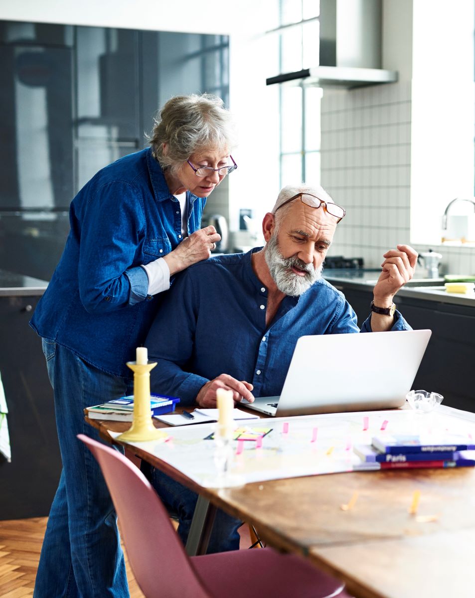 elderly man and women on their computer