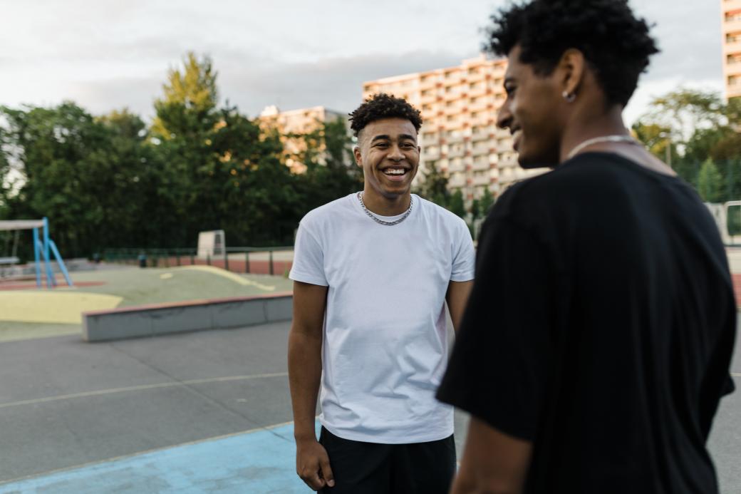 Two young people chatting at a park