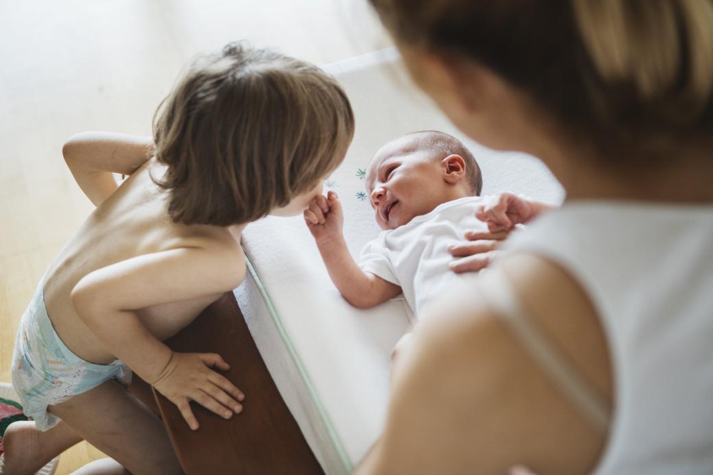 Woman with newborn and toddler 